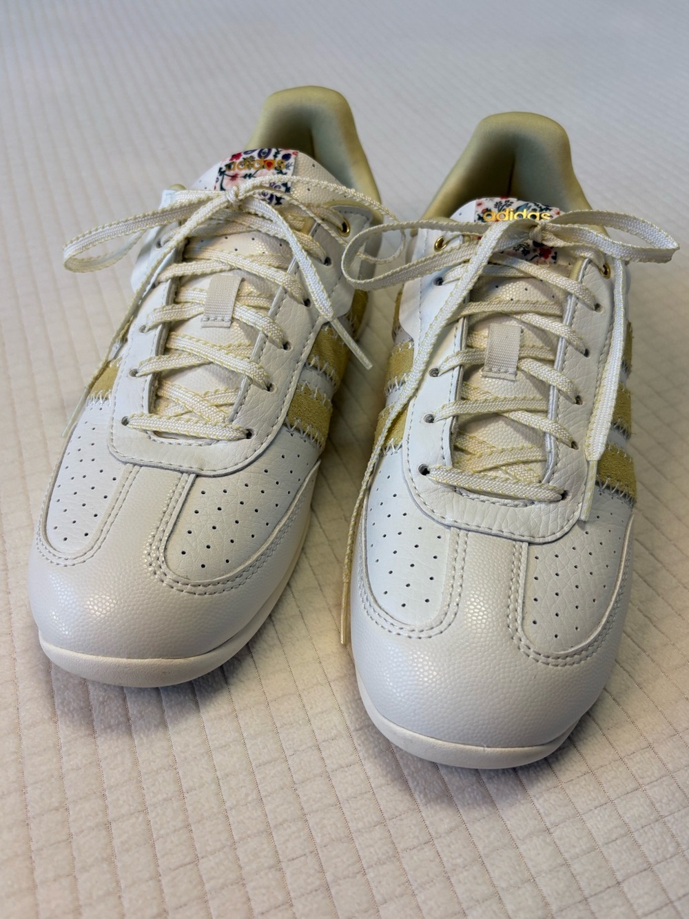 Adidas cream colored sneakers with floral accents